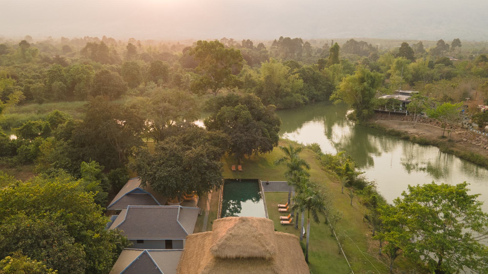 Khla Lodge at dusk, aerial view over the river